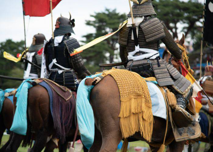 Samurai on horseback, as seen as behind. A view to be discovered at the Soma Nomaoi Wild Horse Chase Festival in Fukushima.